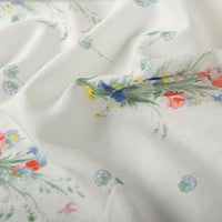 A close-up of Longan Craft Floral Digital Print Voile Fabric by the Yard shows soft, lightweight cotton voile with a vibrant red, blue, and yellow floral print—perfectly breathable for airy tops and summer styles.