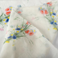 Longan Craft Floral Digital Print Voile Fabric by the yard features a lightweight, breathable cotton voile with clusters of red, blue, and yellow flowers and green leaves on soft, semi-transparent material—perfect for airy tops.