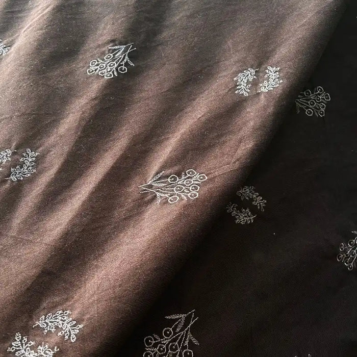 Longan Craft’s Floral Embroidered Cotton Corduroy Fabric By The Yard is a brown pinwale corduroy material with delicate white floral embroidery, featuring a rich texture and soft folds—ideal for autumn sewing projects.