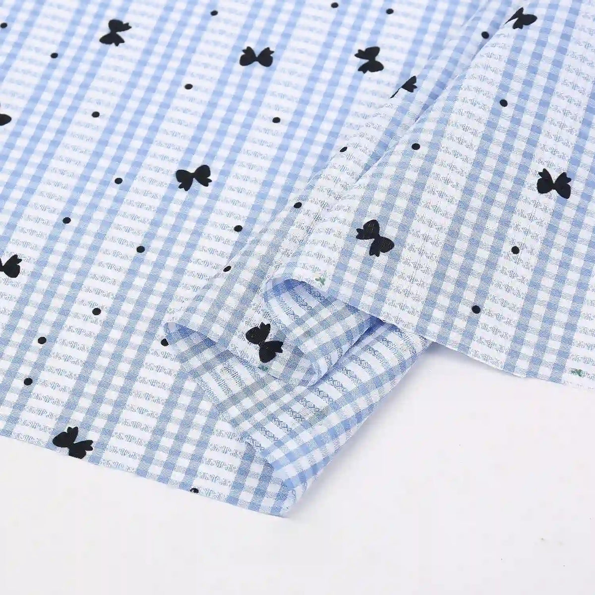 Longan Craft's Floral Gingham Quilting Fabric By The Yard is a comfy polyester quilting material with a botanical pattern—ideal for casual wear or your next quilted project. Shown partially folded on a white background.