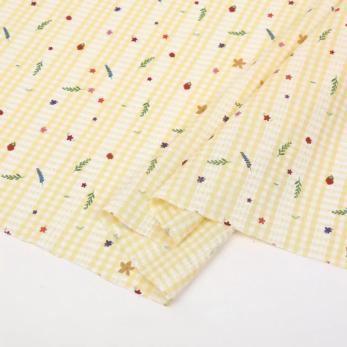 Longan Craft's Floral Gingham Quilting Fabric By The Yard features a vibrant botanical pattern on polyester—perfect for quilting or casual wear. This comfy quilting material brings colorful florals and green leaves to your next creative project.