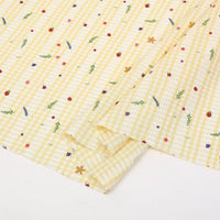 Longan Craft's Floral Gingham Quilting Fabric By The Yard features a vibrant botanical pattern on polyester—perfect for quilting or casual wear. This comfy quilting material brings colorful florals and green leaves to your next creative project.