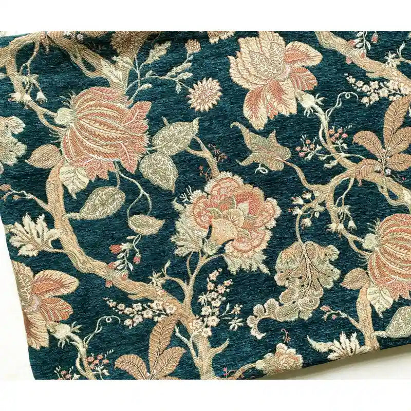 A close-up of Longan Craft Floral Jacquard Chenille Fabric By The Yard showcases heavyweight poly chenille upholstery with ornate beige, pink, and green floral tapestry on a teal background—ideal for home decor.