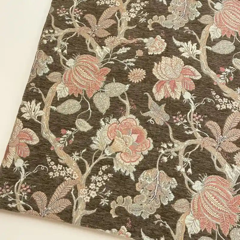 Longan Craft’s Floral Jacquard Chenille Fabric By The Yard is a heavyweight poly chenille upholstery fabric, ideal for elegant home decor projects with its intricate floral design in pink, cream, and green on a brown background.