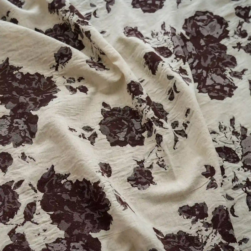 A close-up of Longan Craft’s Floral Jacquard Cotton Linen Fabric by the yard, featuring a multicolor botanical flower print and a textured finish—ideal DIY material for dressmaking and creative projects.