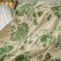 The Longan Craft Floral Jacquard Cotton Linen Fabric features large green and yellow botanical prints on a beige background, perfect for dressmaking. Sold by the yard. Sheer curtain shown for styling inspiration.