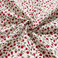 Longan Craft’s Floral Printed Cotton Crepe Fabric By The Yard features a soft washed crepe material adorned with a delicate botanical pattern of small red flowers and green leaves. Gathered in a swirl at the center, the fabric displays gentle folds and texture across its surface, while the evenly distributed floral print adds charm to this comfortable textile—ideal for dresses and creative projects.