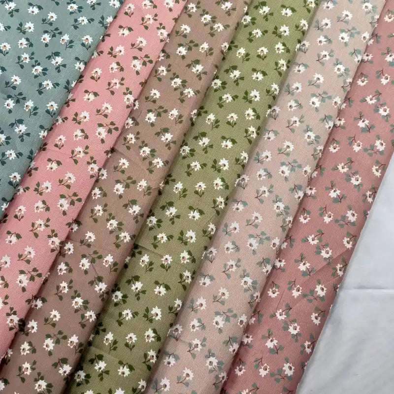 Longan Craft's Floral Printed Peachskin Fabric by the Yard features soft microfiber polyester in blue, pink, brown, green, and beige shades with small white flowers—perfect for comfy apparel projects.