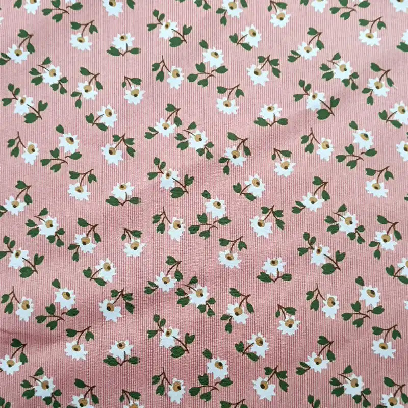 Longan Craft's Floral Printed Peachskin Fabric By The Yard features soft microfiber polyester with a comfy peachskin texture, adorned with small white flowers, yellow centers, and green leaves on a subtly striped pink background.