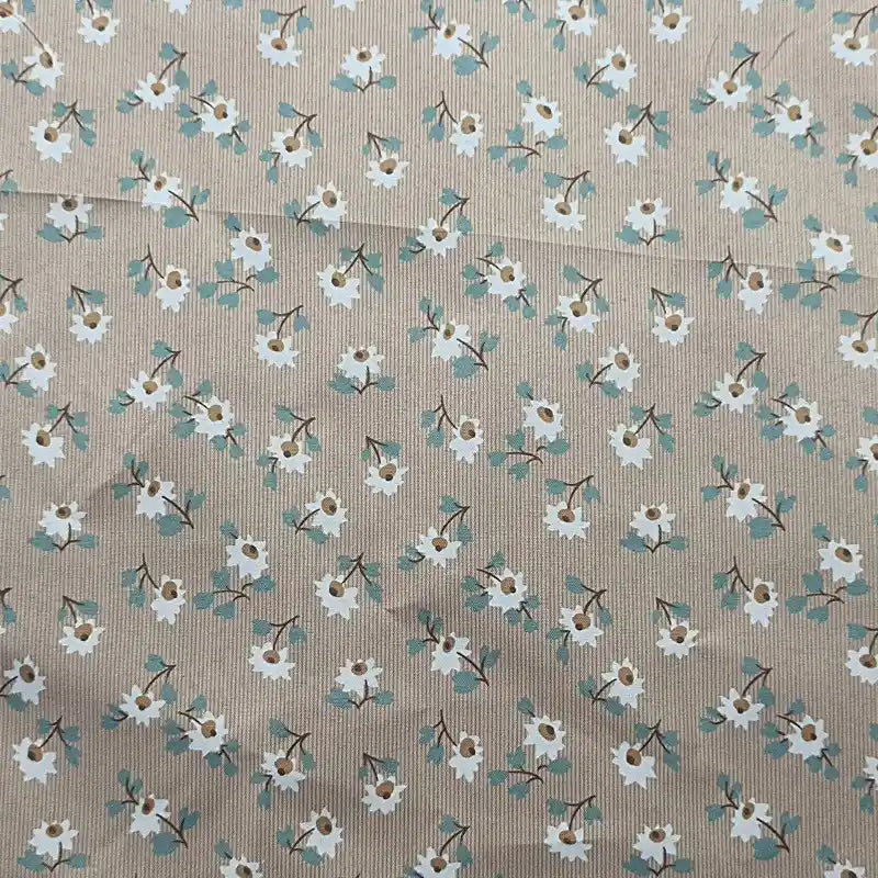 Longan Craft's Floral Printed Peachskin Fabric by the yard features a beige microfiber polyester base with a small white floral pattern, green leaves, and brown flower centers scattered across its comfy peachskin texture—perfect for apparel.