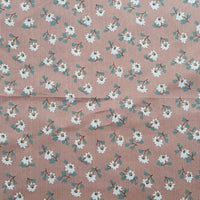 Longan Craft’s Floral Printed Peachskin Fabric by the yard features soft microfiber polyester with small white flowers, yellow centers, and green leaves on a light brown striped background—ideal for comfy apparel.