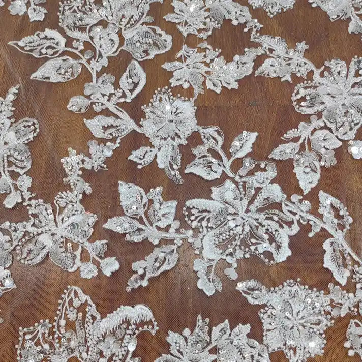 The Longan Craft Floral Sequin Embroidered Tulle Fabric by the yard features heavyweight floral embroidery and sequins on sheer tulle, making it perfect for wedding dresses or decorative projects.