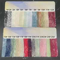 A display of 25 Longan Craft Floral Sequin Lace Fabric by the yard samples, in vibrant colors labeled 1# to 25#, showcases delicate patterns—perfect for bridal and evening gowns, highlighting colorful sparkling lace material for dresses.