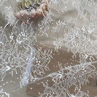 Floral Sequin Lace Fabric By The Yard from Longan Craft features colorful sparkling lace material, ideal for elegant dresses. Its intricate embroidered patterns make it perfect for wedding gowns or veils.