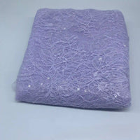 A piece of Floral Sequin Lace Fabric By The Yard from Longan Craft, featuring colorful sparkling lace and floral patterns for dresses, is displayed folded on a plain white surface.