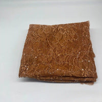 A folded piece of Longan Craft Floral Sequin Lace Fabric By The Yard—colorful sparkling lace with a delicate floral pattern—ideal for dresses, displayed on a plain white surface.