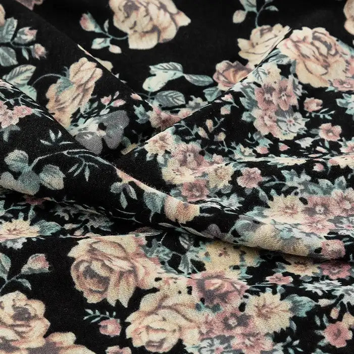 Close-up of Longan Craft's Floral and Animal Printed Jersey Fabric by the yard, made from 100% cotton. Features a vintage-style print with pink and beige roses, green leaves, and softly folded texture ideal for jersey clothing material.