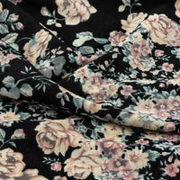 Close-up of Longan Craft's Floral and Animal Printed Jersey Fabric by the yard, made from 100% cotton. Features a vintage-style print with pink and beige roses, green leaves, and softly folded texture ideal for jersey clothing material.
