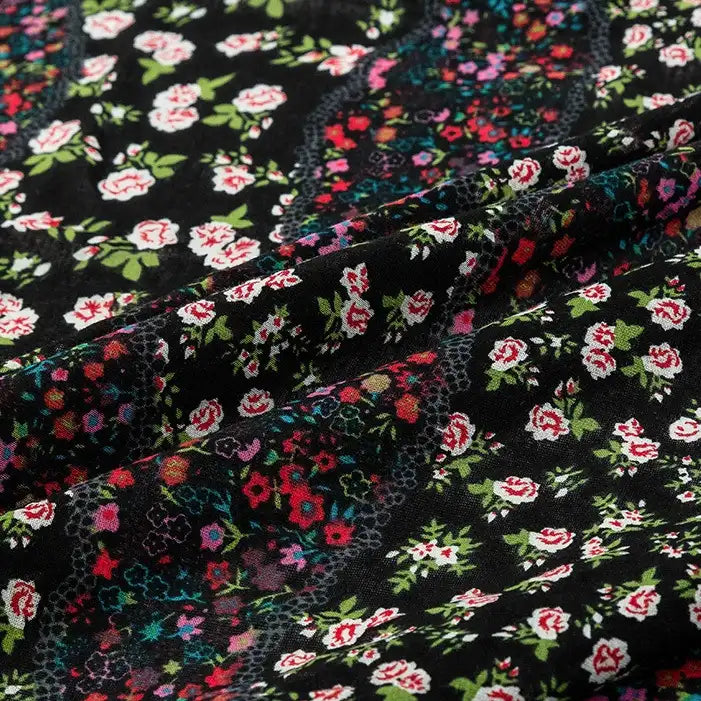 Close-up of Longan Craft’s Floral and Animal Printed Jersey Fabric by the yard, made from 100% cotton. The fabric features colorful floral patterns with red, white, and pink flowers plus green leaves, showcasing its soft texture and depth.