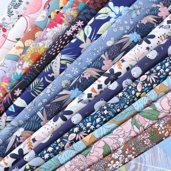 A vibrant selection of Longan Craft’s Floral Animal Printed Microfiber Peachskin Fabric by the yard, featuring multicolor polyester with floral, plant, and animal motifs—ideal for dressmaking and fans of bold, whimsical prints.
