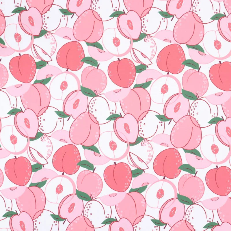 A playful, vibrant design of pink peaches and slices with green leaves on white, perfect for dresses using Longan Craft's Floral Animal Printed Microfiber Peachskin Fabric By The Yard—multicolor polyester with a peachskin texture.