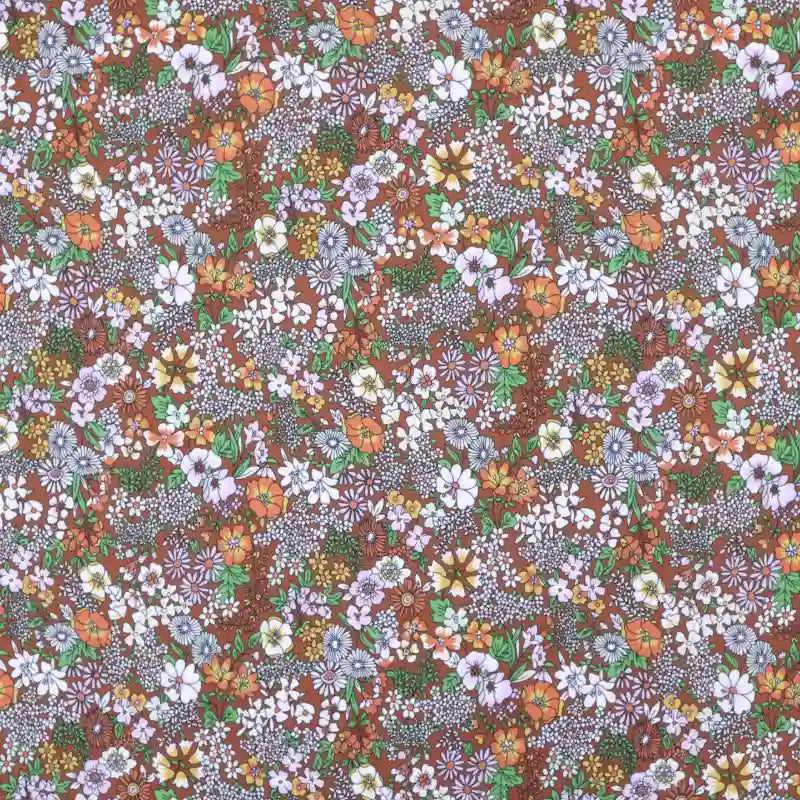 The Longan Craft Floral Animal Printed Microfiber Peachskin Fabric features a colorful multicolor floral pattern with small white, purple, orange, and yellow flowers plus green leaves on a brown background—ideal for dresses.