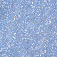 Longan Craft's Floral Animal Printed Microfiber Peachskin Fabric by the yard features delicate multicolor flowers and leaves on a light blue background, creating a gentle, airy feel—ideal polyester peachskin material for dresses.