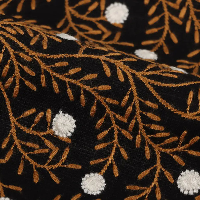 Close-up of Flower Embroidered Linen Fabric By The Yard by Longan craft, featuring black linen with golden-brown leafy branches and white floral embroidery, ideal for sewing dresses.
