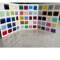 A display board with three panels presents colorful Longan Craft Georgette Silk Fabric swatches (8 Momme Pure Mulberry Silk Crepe) in a grid, showcasing a range of vibrant shades across the spectrum on a light, reflective surface.