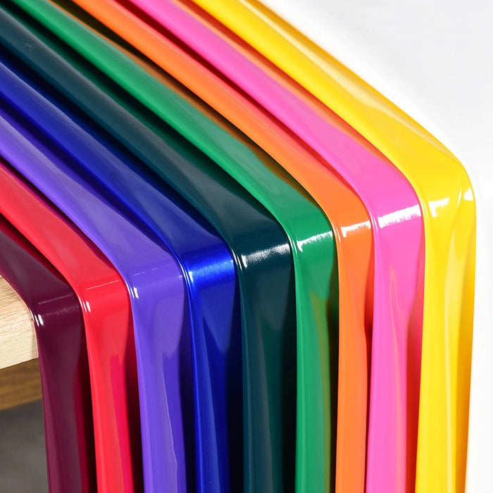 Longan Craft’s Glossy Stretch Vinyl Fabric by the yard shines in solid colors—purple, red, blue, green, orange, pink, and yellow—neatly arranged on a light wooden surface; perfect for making jackets.