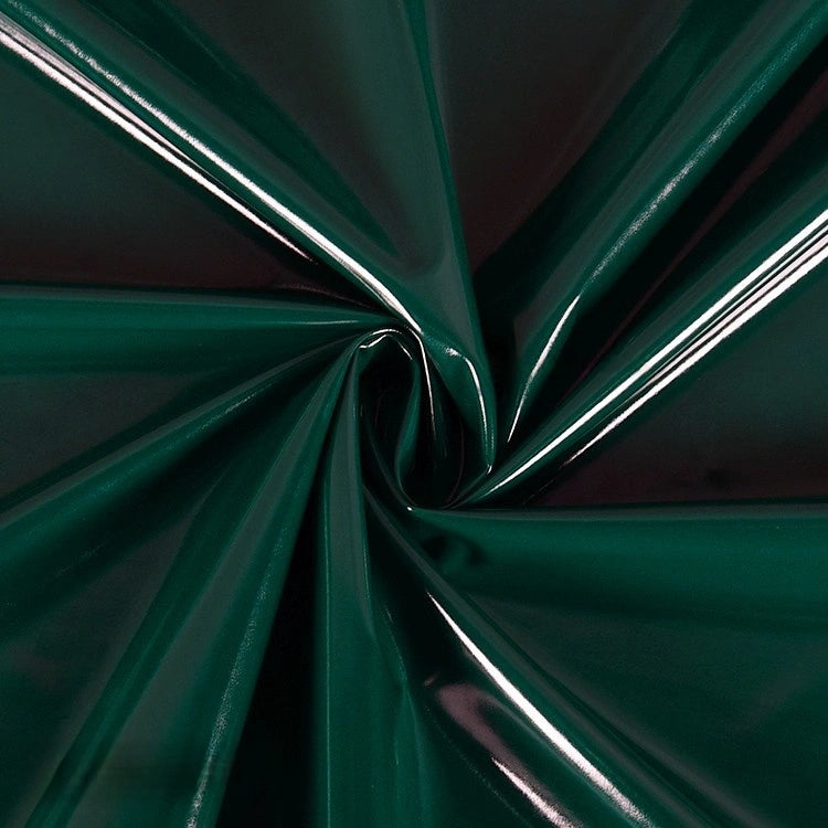 Close-up of Longan Craft's Glossy Stretch Vinyl Fabric by the yard, gathered and twisted at the center, showing folds and reflective highlights on the shiny solid color PU surface—ideal for making jackets.