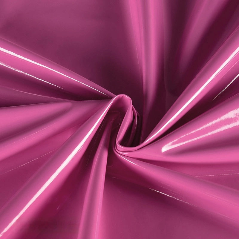 Longan Craft Glossy Stretch Vinyl Fabric by the yard features shiny pink PU material with a lustrous finish, gathered and twisted at the center to create folds and highlights—perfect for making jackets.