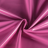 Longan Craft Glossy Stretch Vinyl Fabric by the yard features shiny pink PU material with a lustrous finish, gathered and twisted at the center to create folds and highlights—perfect for making jackets.