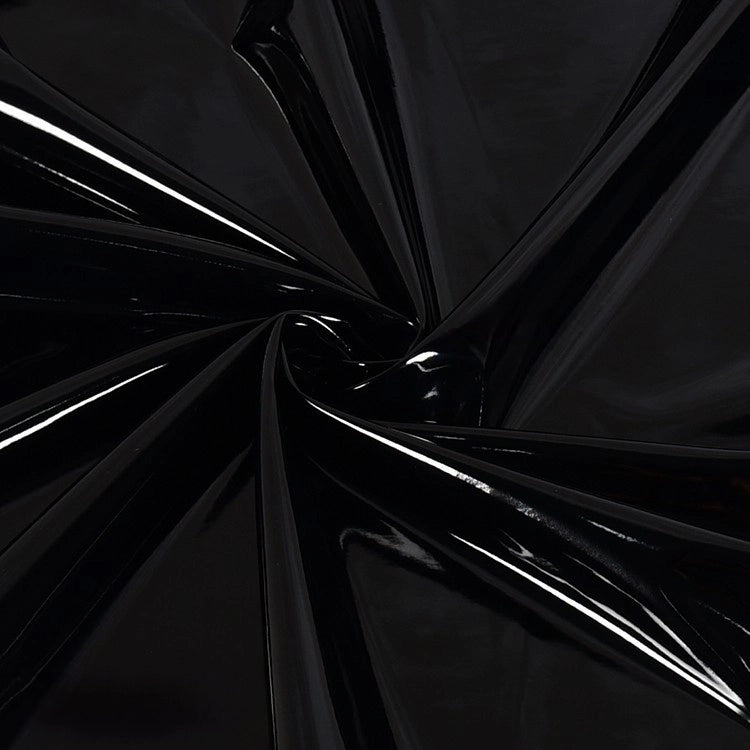 A close-up of Longan Craft's Glossy Stretch Vinyl Fabric by the yard, showing shiny PU material with reflective folds and dynamic lines—ideal for making jackets.