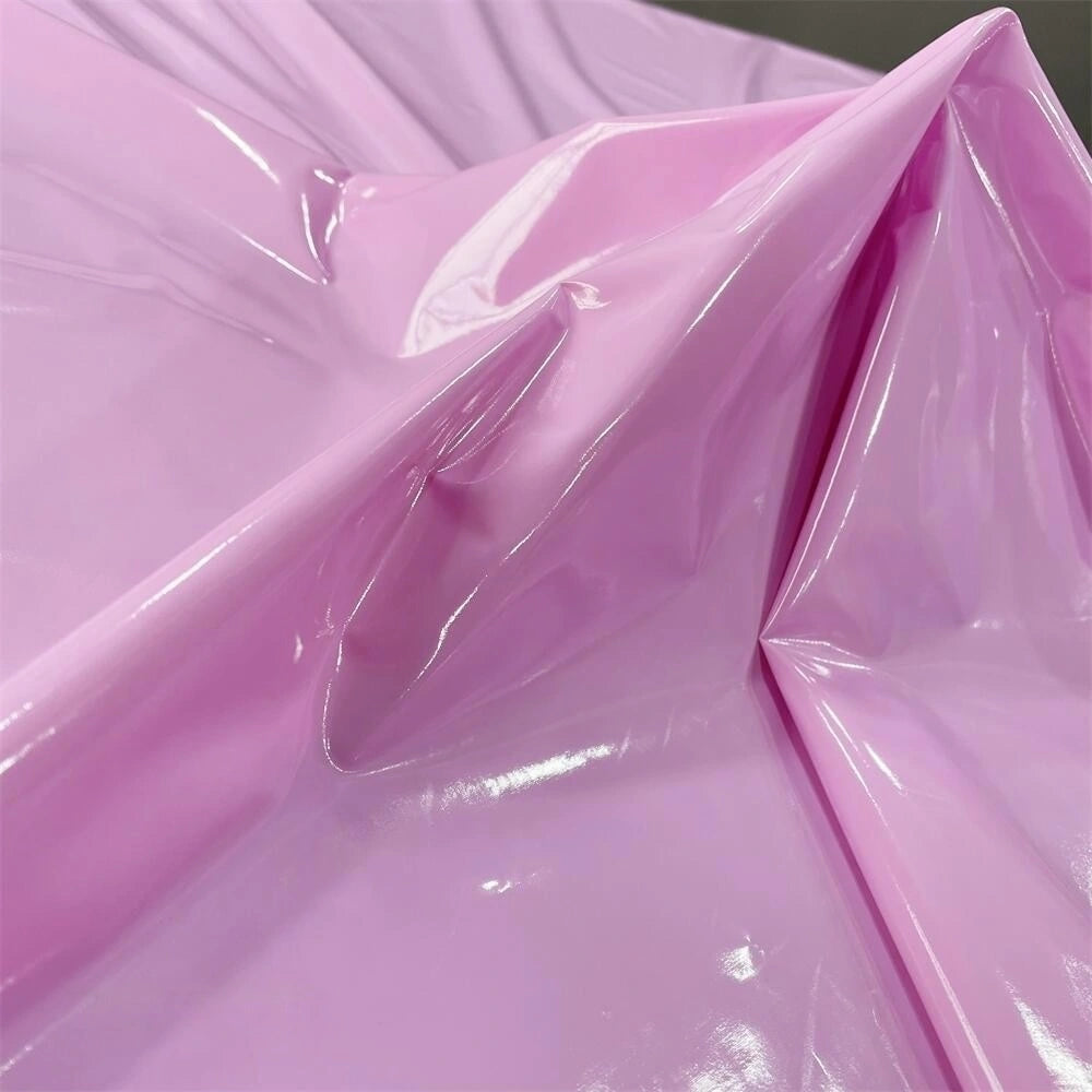 A close-up of Longan Craft's glossy stretch vinyl fabric by the yard, a shiny solid color PU material with mirror-like folds and reflections—perfect for making jackets.