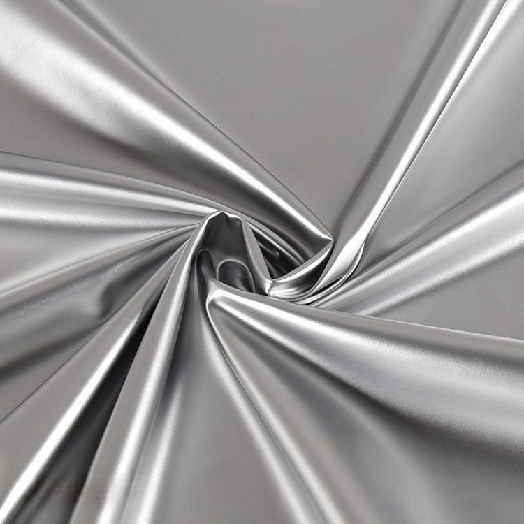 Longan Craft’s Glossy Stretch Vinyl Fabric By The Yard features solid color shiny PU vinyl gathered and twisted at the center, creating soft folds and a reflective, smooth finish—perfect for making jackets.