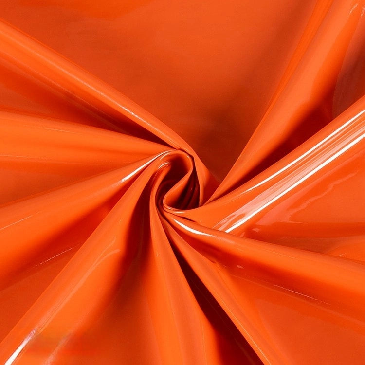 Longan Craft's Glossy Stretch Vinyl Fabric by the yard features a shiny, solid PU finish in orange, with gathered and twisted details that create smooth folds—perfect for making jackets.