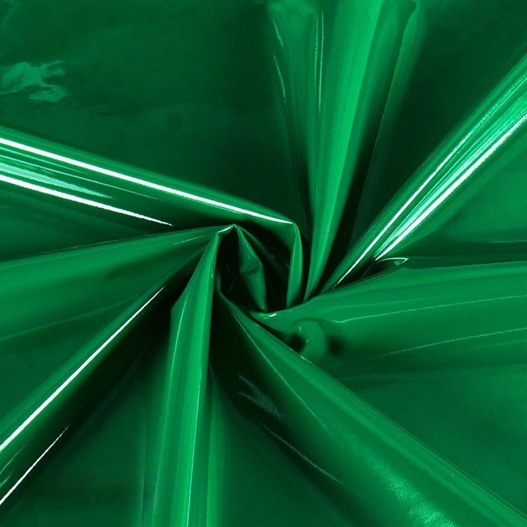 Longan Craft’s Glossy Stretch Vinyl Fabric by the Yard features shiny green PU material, ideal for jackets. Its smooth, crumpled surface reflects light with striking highlights and shadows.