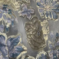 Close-up of Longan Craft’s Golden Floral Jacquard Organza Fabric by the yard, showcasing purple flower patterns and intricate gold embroidery on a sheer, translucent organza—perfect organza material for dressmaking.