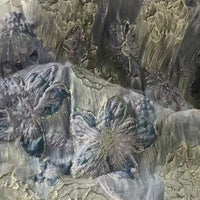Close-up of Longan Craft's Golden Floral Jacquard Organza Fabric, featuring metallic and pastel patterns with layered purple flower motifs. This delicate organza material is perfect for dressmaking by the yard.