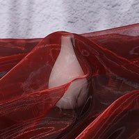 A light pink ceramic vase is partially draped with Longan Craft’s Gradient Organza Fabric By The Yard, a lightweight ombre organza material, set against a textured gray background that highlights its bridal-gown-inspired elegance.