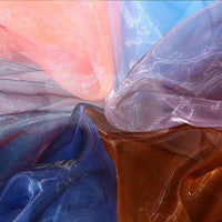 Longan Craft's Gradient Organza Fabric By The Yard features lightweight, soft ombre organza in pink, blue, violet, brown, and orange—creating a vibrant abstract effect ideal for elegant gown designs.