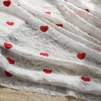 Longan craft’s Heart Embroidered Tassel Chiffon Fabric features sheer white jacquard chiffon, red heart embroidery, and a fuzzy texture, making it ideal for sewing spring and summer women's dresses.