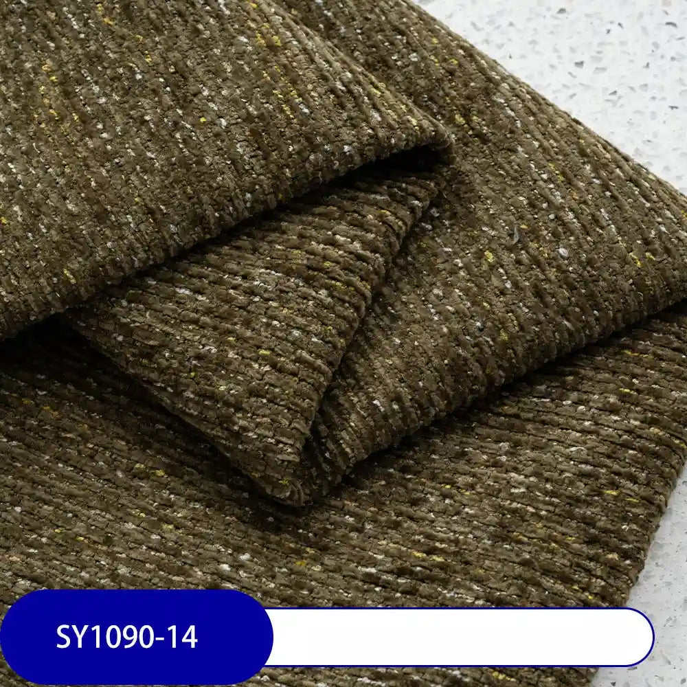 A close-up of Longan Craft's Heavy Weight Slub Chenille Fabric By The Yard, showing thick, textured brown material with yellow and gray flecks. Label at the bottom displays SY1090-14 in white text on a blue background.