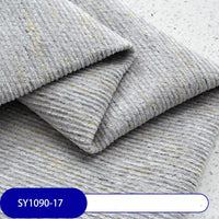A folded piece of Longan Craft Heavy Weight Slub Chenille Fabric By The Yard in light gray with yellow flecks is shown on a flat surface. The thick, textured polyester upholstery fabric features a SY1090-17 label in white on blue.