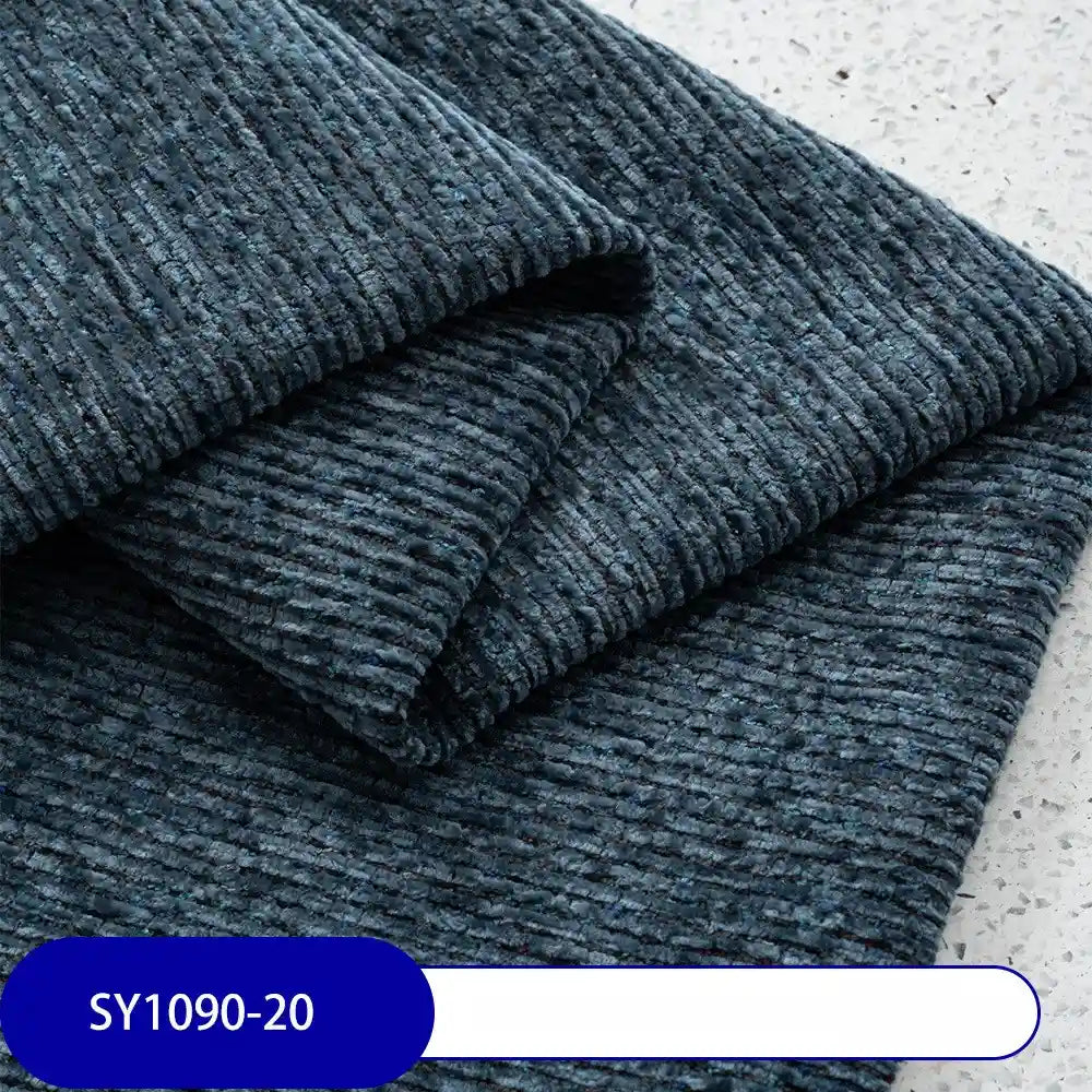Close-up of folded dark blue Heavy Weight Slub Chenille Fabric by Longan Craft, showing horizontal ridges on a light speckled surface. Label at bottom left reads SY1090-20. This is premium thick polyester chenille upholstery fabric by the yard.