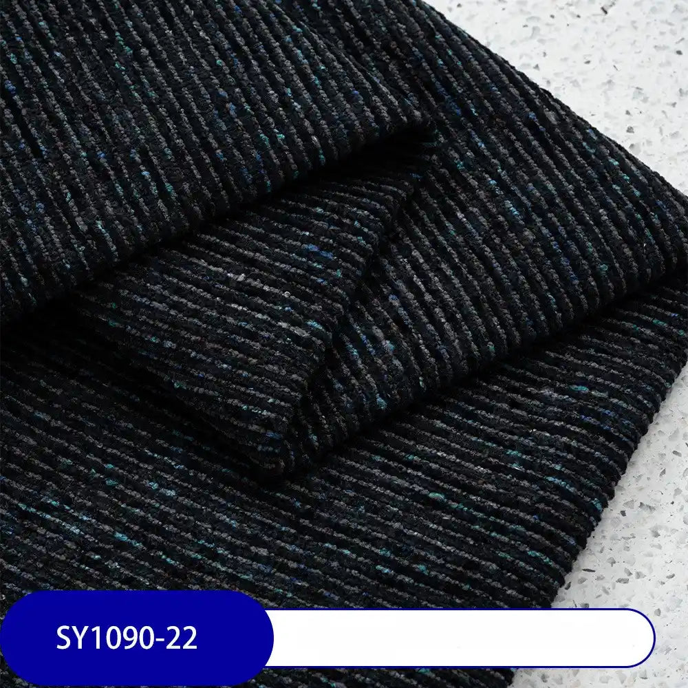 Heavy Weight Slub Chenille Fabric by Longan Craft in black, featuring fine blue and gray horizontal lines, is displayed folded on a speckled surface. A label at the bottom left shows “SY1090-22” in white text on a blue background.