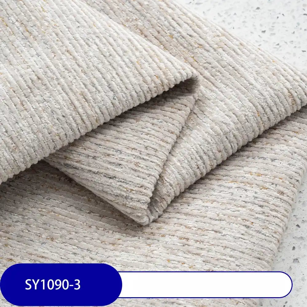 Folded pieces of Longan Craft's Heavy Weight Slub Chenille Fabric By The Yard, a thick polyester chenille upholstery material in textured light grey with subtle stripes, are displayed with the code SY1090-3 on a blue label.