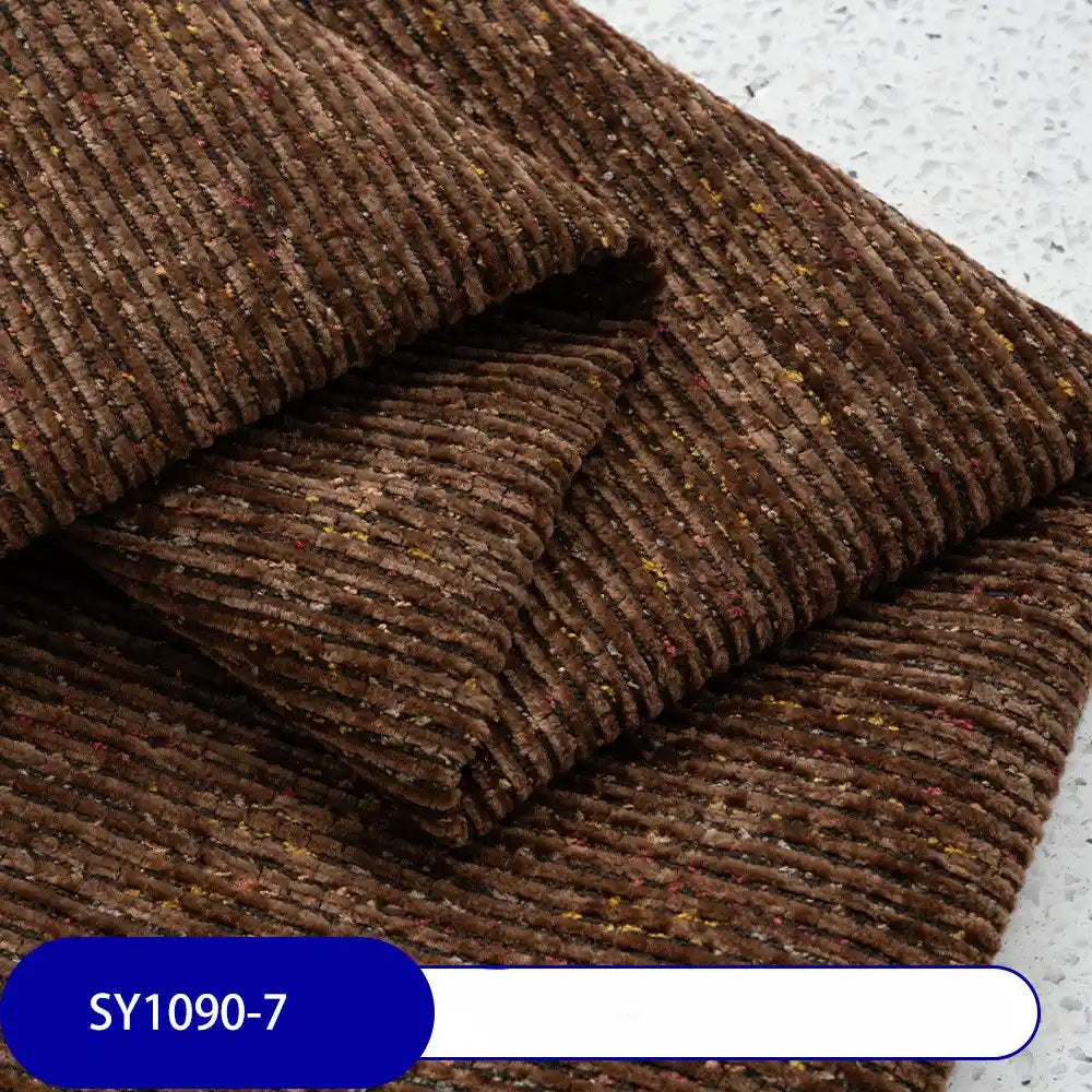Heavy Weight Slub Chenille Upholstery Fabric by Longan Craft in brown multicolor, featuring subtle specks. Thick premium polyester chenille, shown on a light textured surface with code SY1090-7 on a blue label.