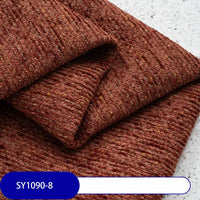 A close-up of Longan Craft’s Heavy Weight Slub Chenille Fabric By The Yard shows its thick, premium polyester in deep reddish-brown with yellow and white flecks—ideal as multicolor chenille upholstery fabric.